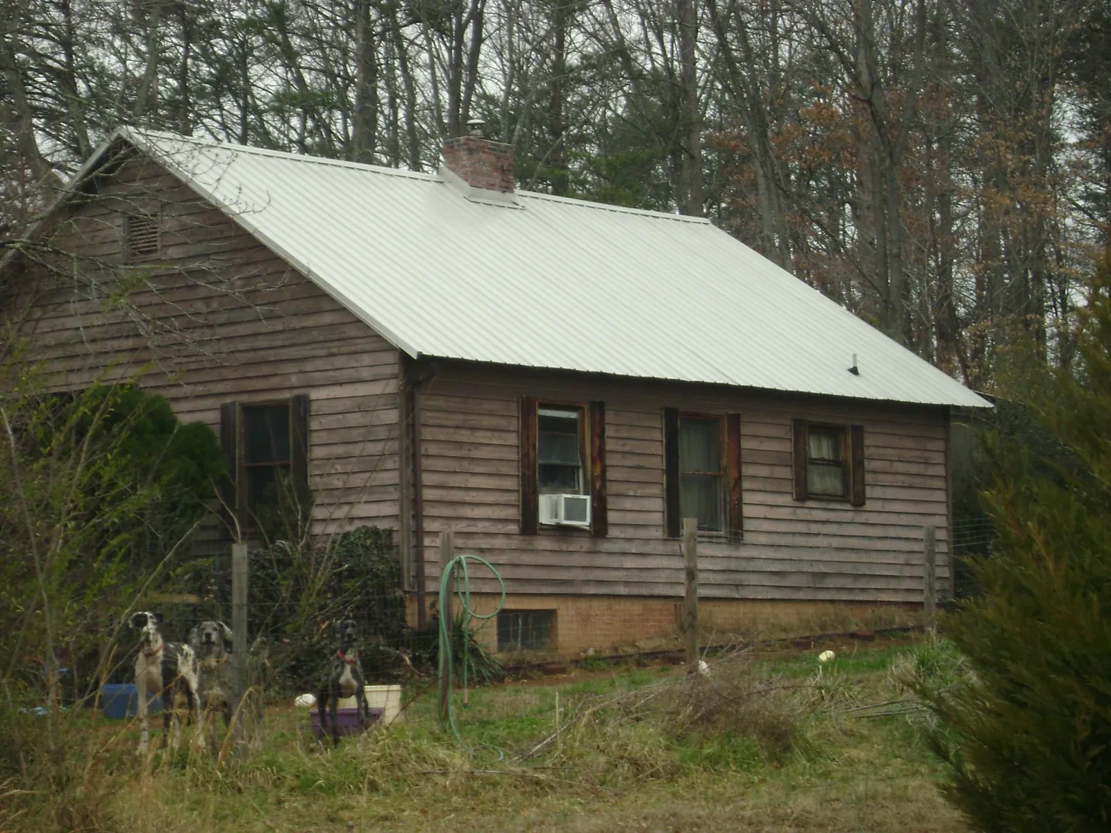 White metal roof on an old wood sided farmhouse, from a Metal Roof Installation job in Fairbanks